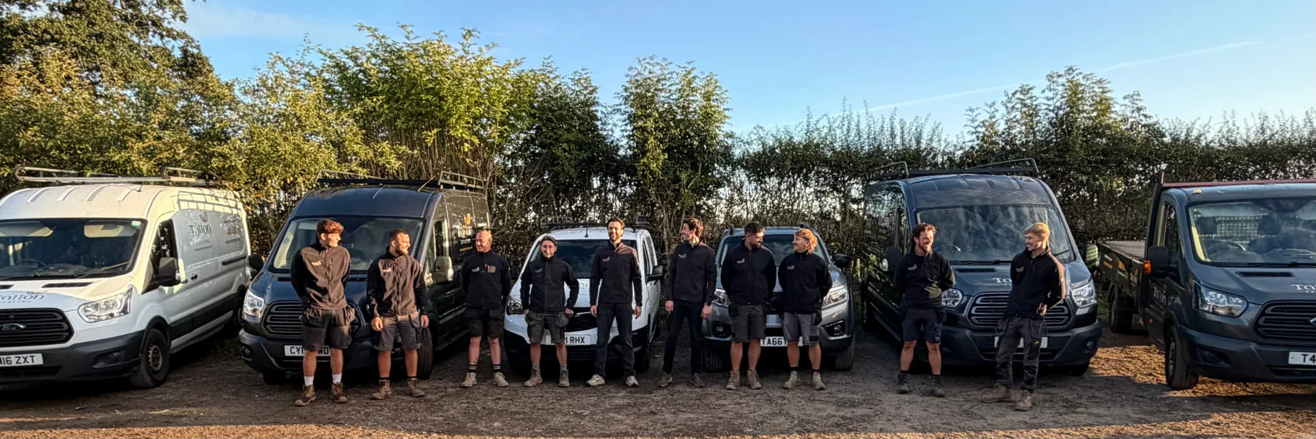 Tatton Fencing team standing together in front of their work vans