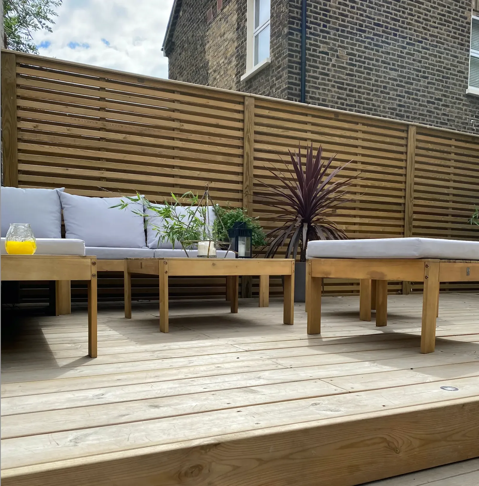 Finished Tatton Fencing garden fence with timber decking and outdoor seating